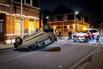 Auto slaat over de kop bij botsing in Tilburg: bestuurder door omstander uit voertuig geholpen